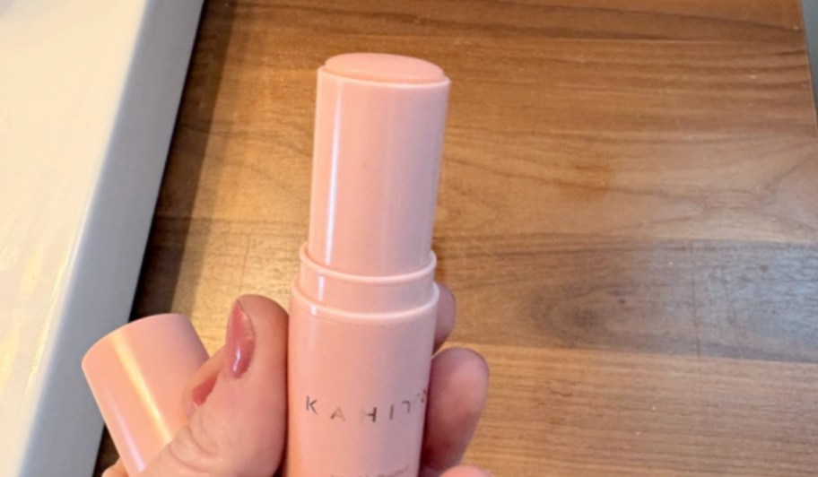kahi balm stick in a woman's hand