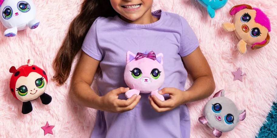 girl holding pink cat plush 