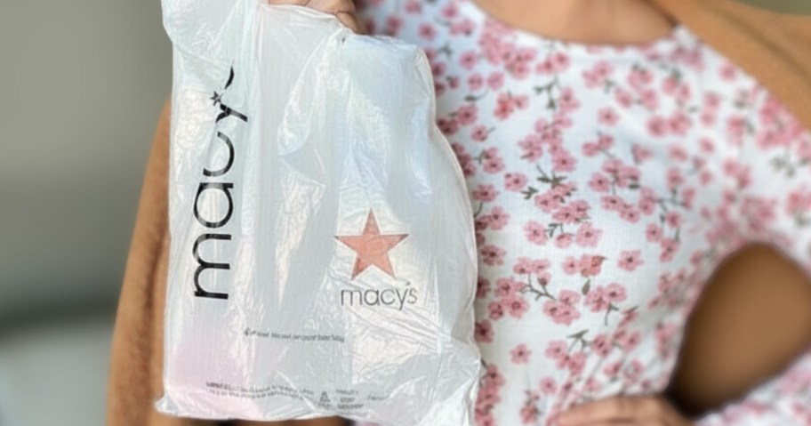 woman holding up a Macy's bag