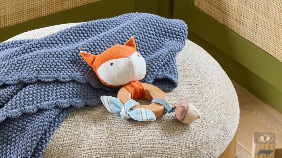 magnolia interactive focx baby toy on an ottoman