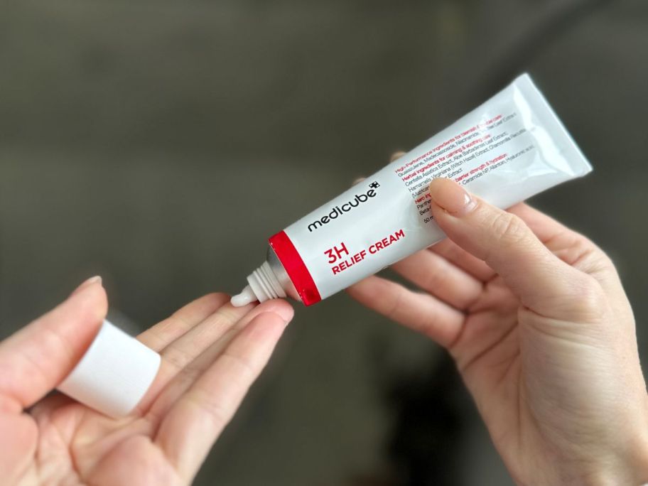 Squeeze Medicube 3H Daily Relief Cream into your other hand.