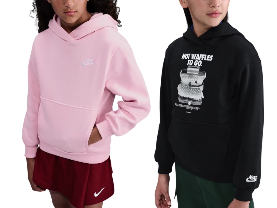 a girl in a pink nike hoodie and a girl in a black graphic nike hoodie
