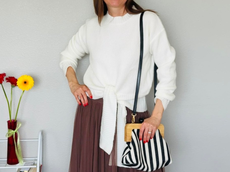 woman wearing white tie-front sweater next to Amazon pricing information