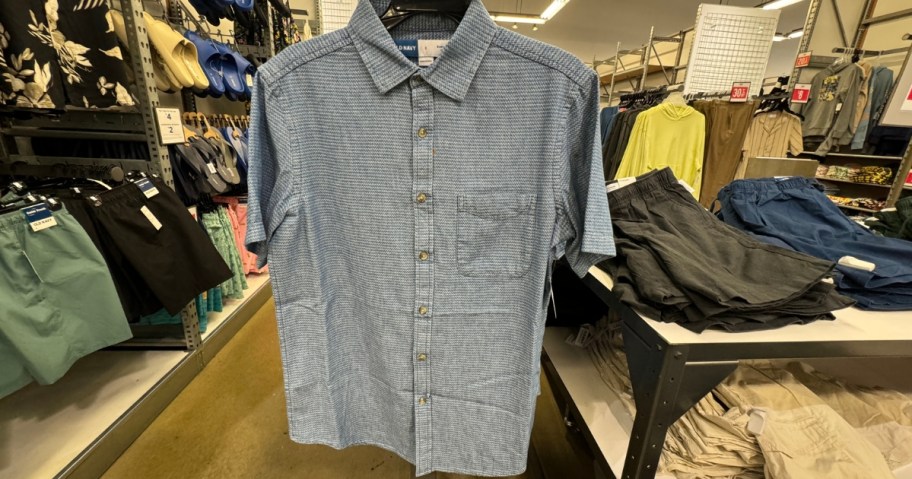 men's button down shirt hanging in a store