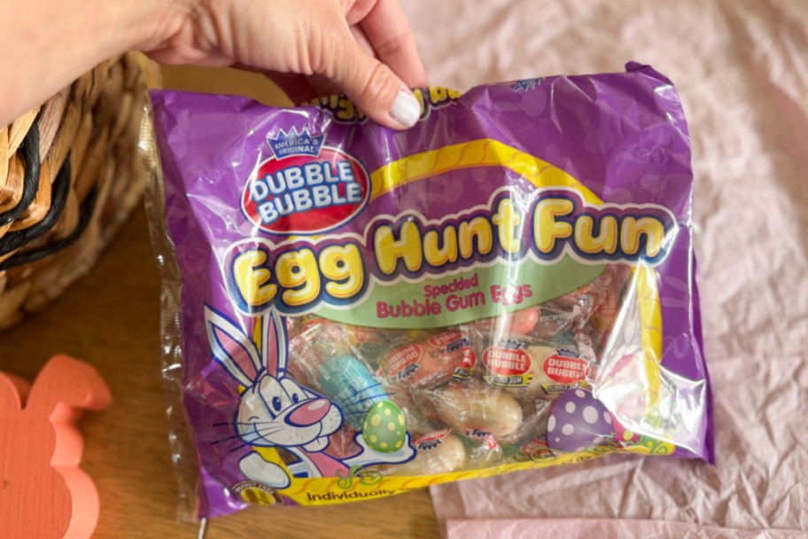 Hand holding a bag of bubblegum eggs