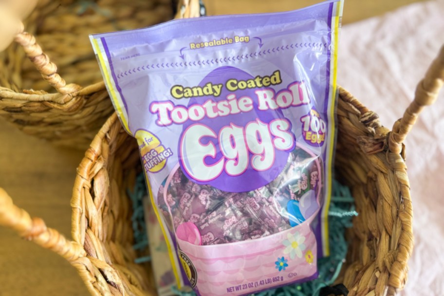 A purple bag of Tootsie Roll eggs in an Easter basket