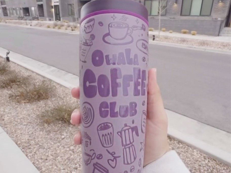 hand holding purple tumbler
