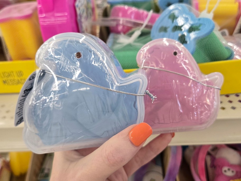 hand holding pink and blue fluffs