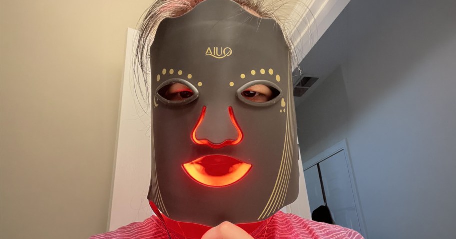 woman wearing a red light therapy mask