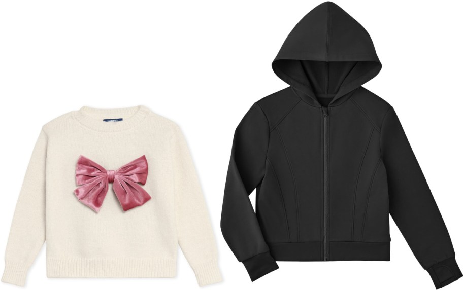 A cream sweater with a large pink velvet bow on the front, next to a plain black zip-up hoodie with a hood. Both garments are laid flat on a white background.