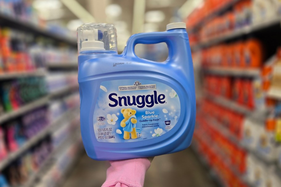 hand holding blue snuggle bottle in aisle
