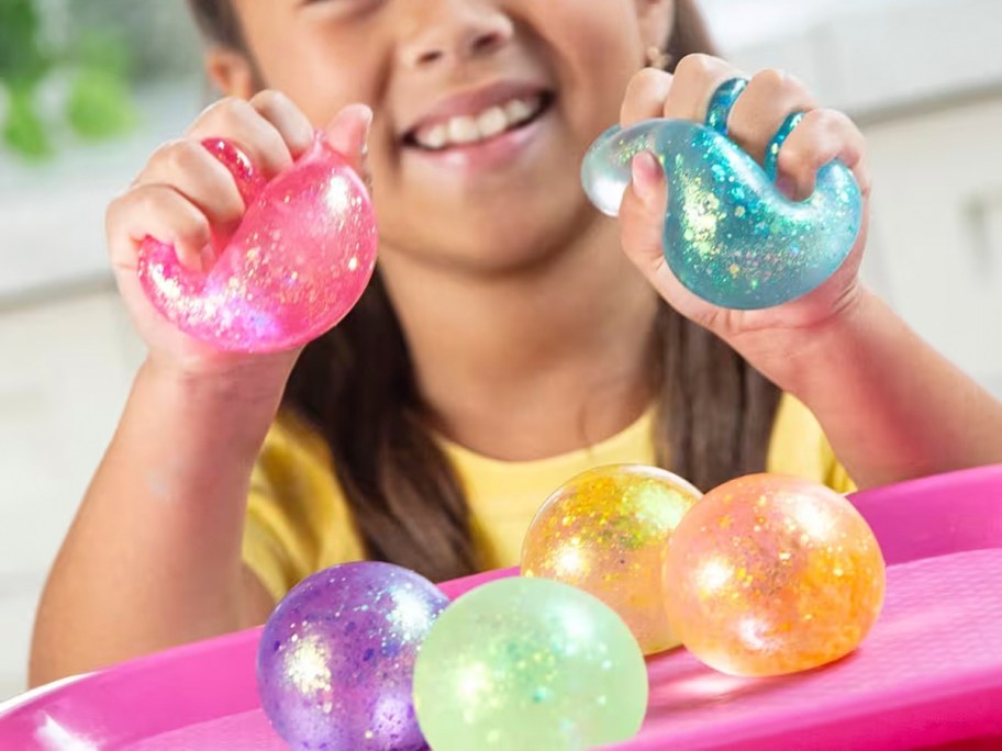 girl playing with squishy ball toys 