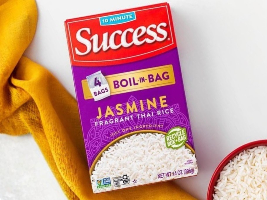 a box of Success Boil in Bag Jasmine Rice with a bowl and napkin