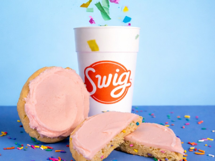 swig cup next to pink cookies