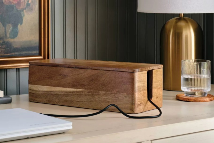 wooden box with black cord sticking out