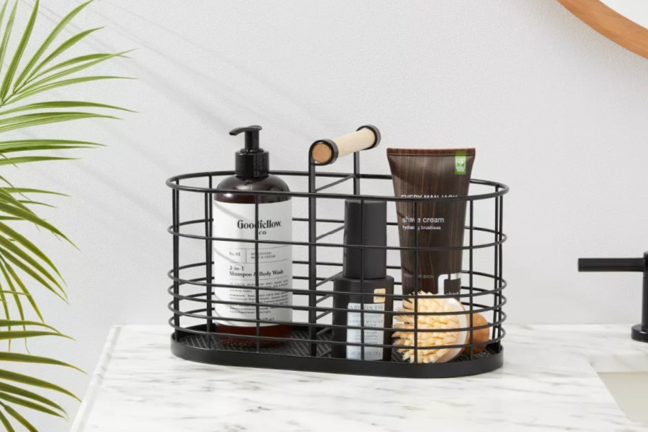 black wire basket with bathroom supplies in it