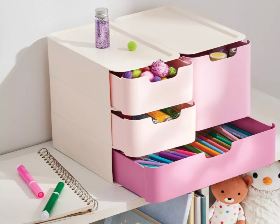 pink drawer organizer with craft supplies coming out