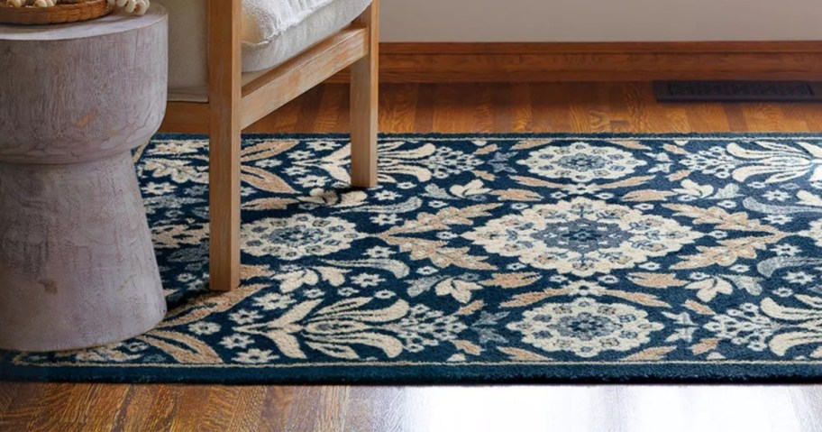 a blue and tan rug in a living room