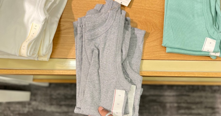 hand reaching for a women's tank on display at Target