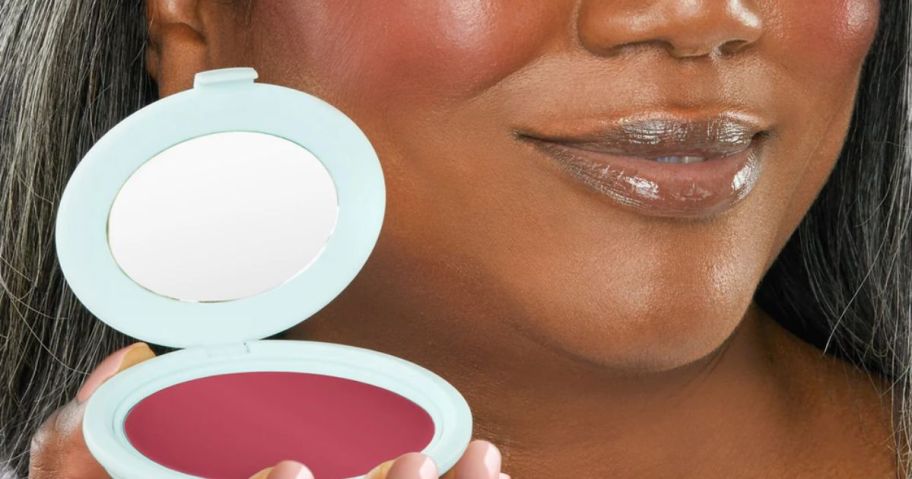 woman holding berry tarte blush