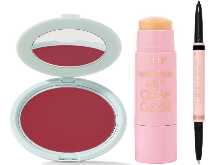 Three makeup products: a pink compact with a mirror and mauve blush, a pink tube of gloss balm, and a double-ended eyeliner stick.