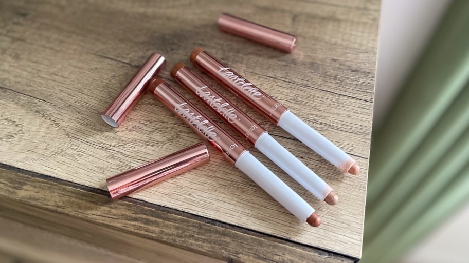 three tarte shadow sticks on a table top