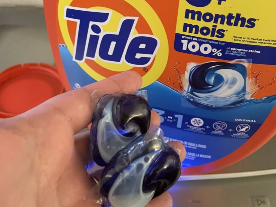holding 2 tide pods