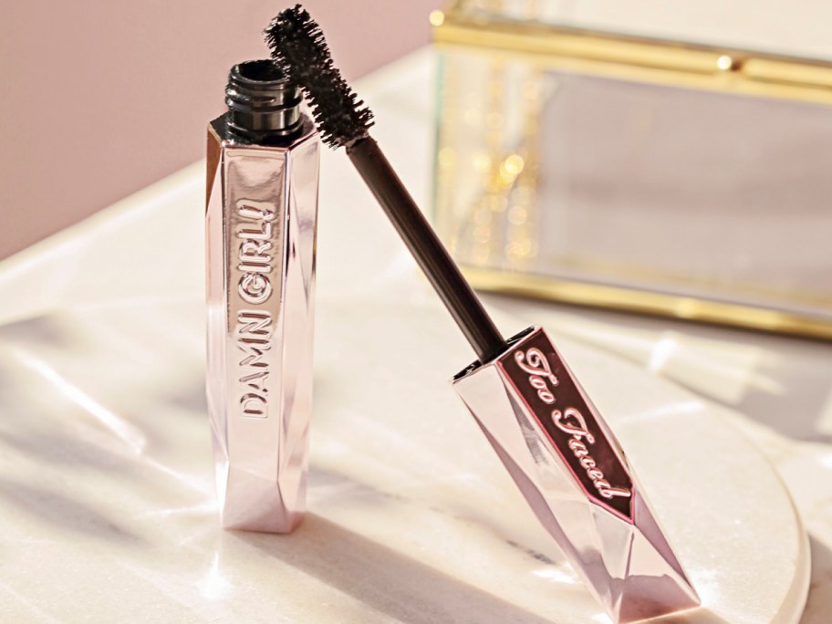 pink too faced mascara on table