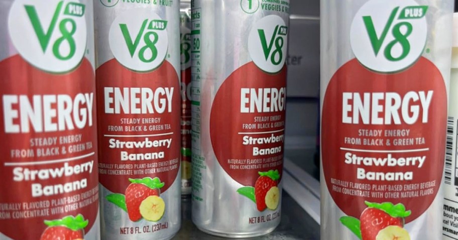 Cans of V8 Energy drink in Strawberry Banana flavor are lined up in a refrigerator.