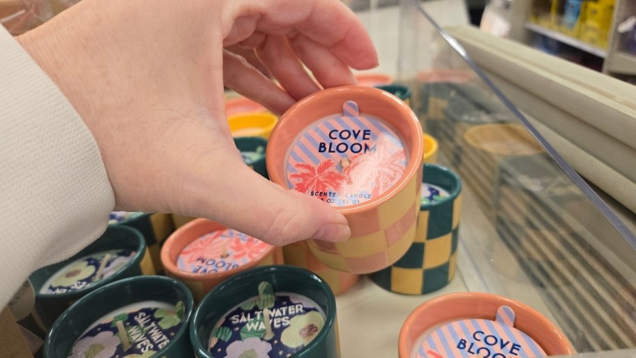 Woman's hand holding votive candle