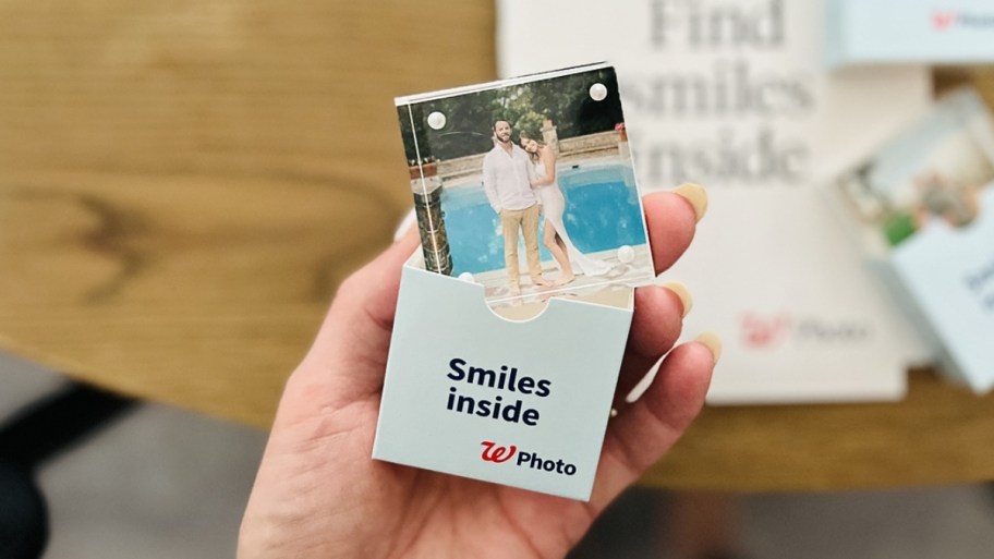 womans hand holding an acrylic photo block