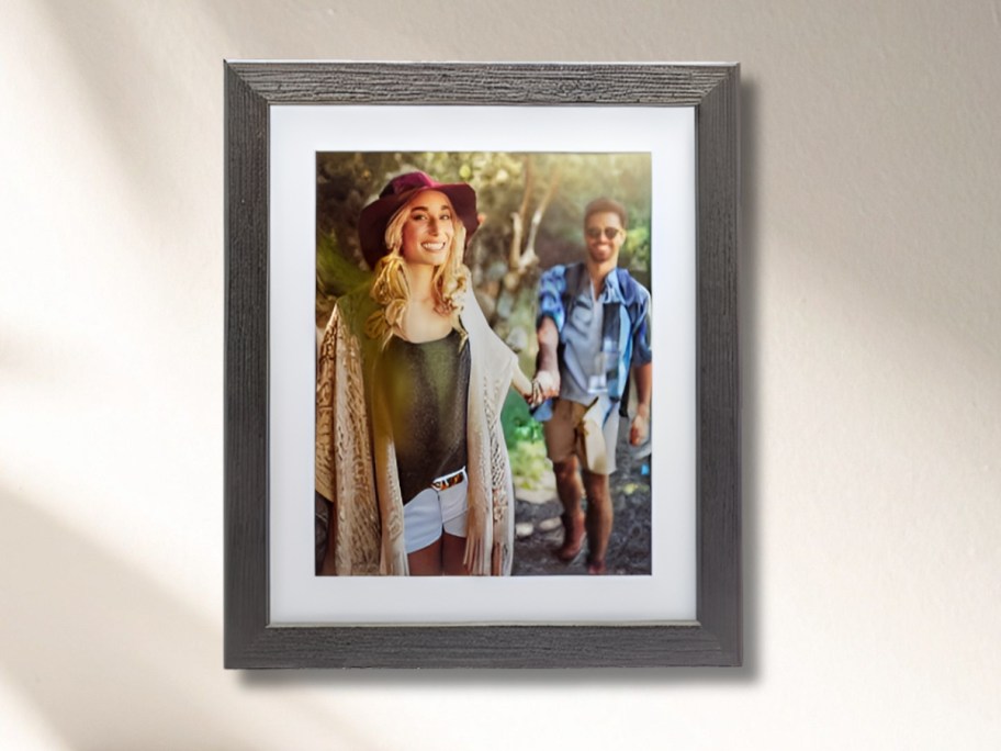 a black framed with white matte print on wall