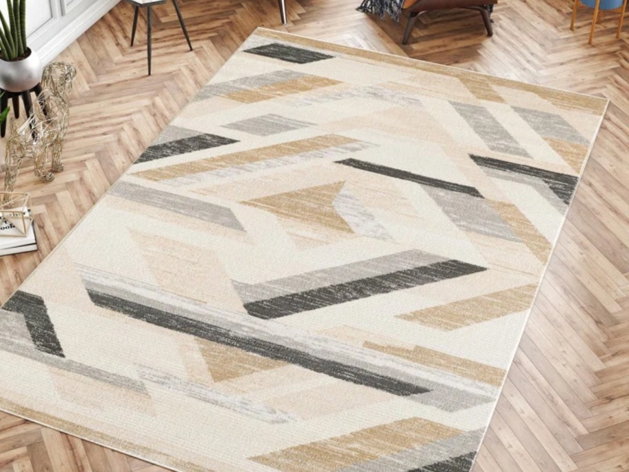 a tan geometric rug in a living room