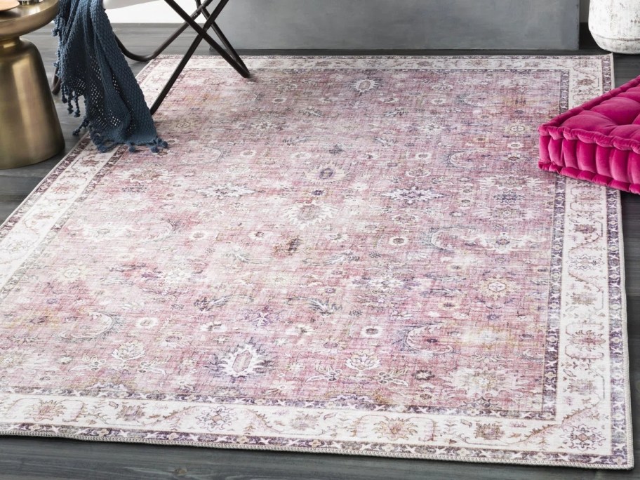 a pink oriental rug in a living room