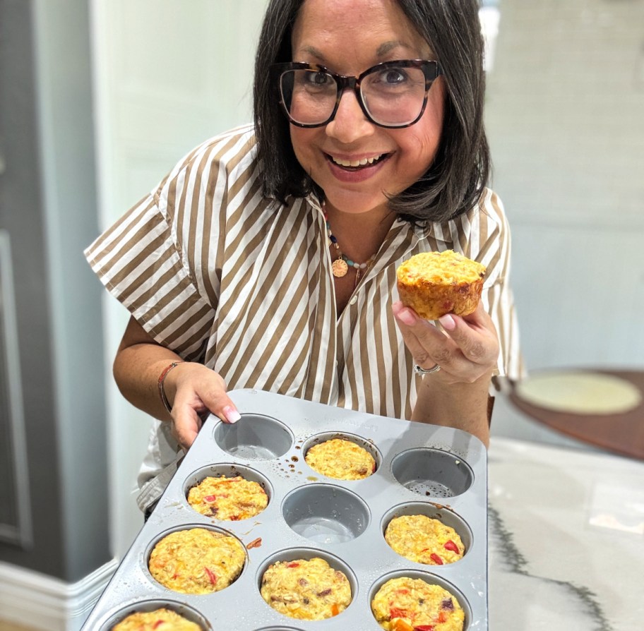 woman holding a tray of cottage cheese oatmeal muffins