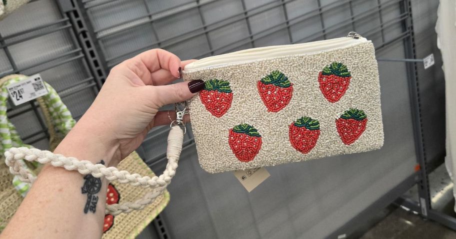 hand holding a wristlet with strawberry print
