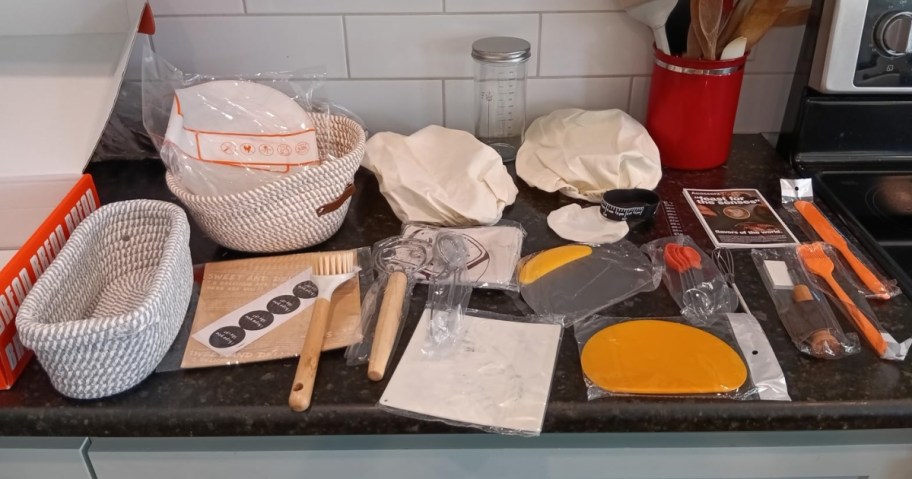 a Sourdough Starter set with kitchen accessories, baskets, and more on a counter
