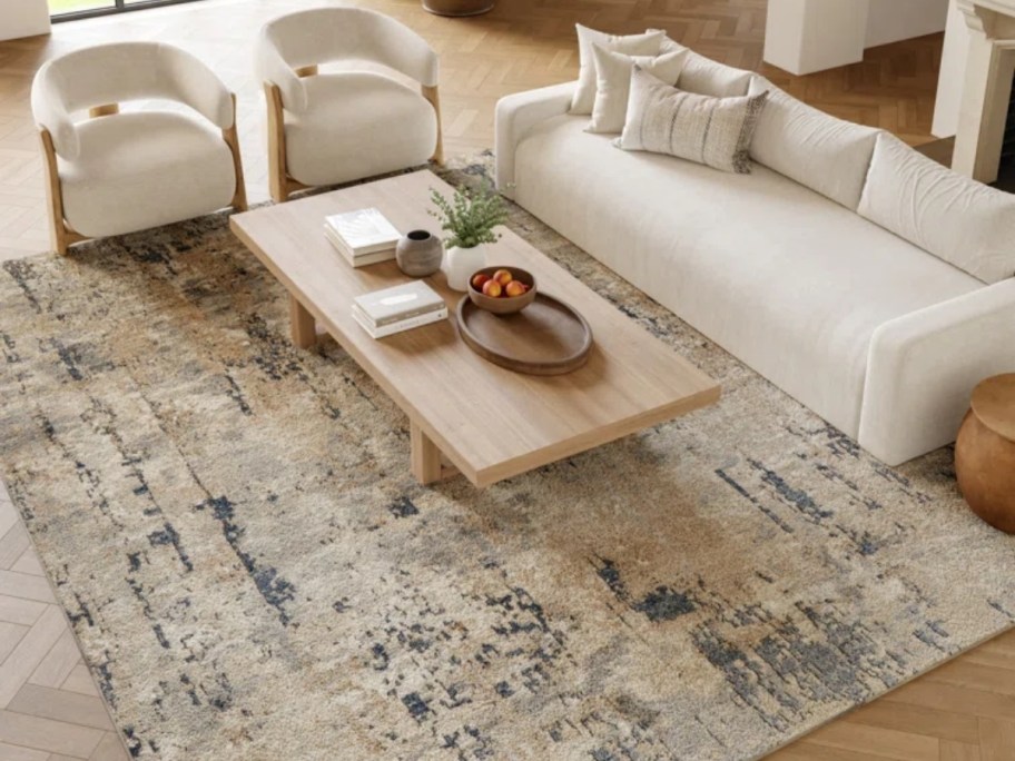 an abstract print rug in beige and gray