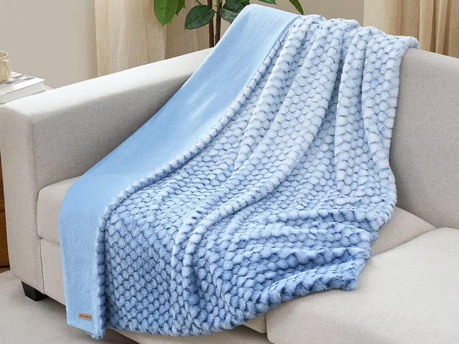 blue throw blanket draped over a couch