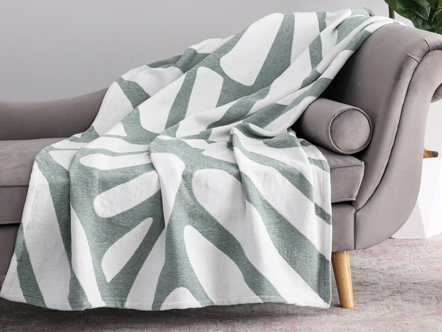 green and white throw draped over a sofa