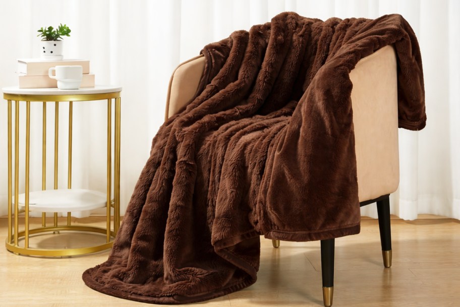 brown throw blanket draped over an accent chair