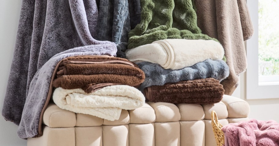 stack of folded fuzzy throw blankets