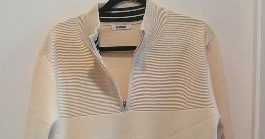 A Coofandy Sweater on a hanger