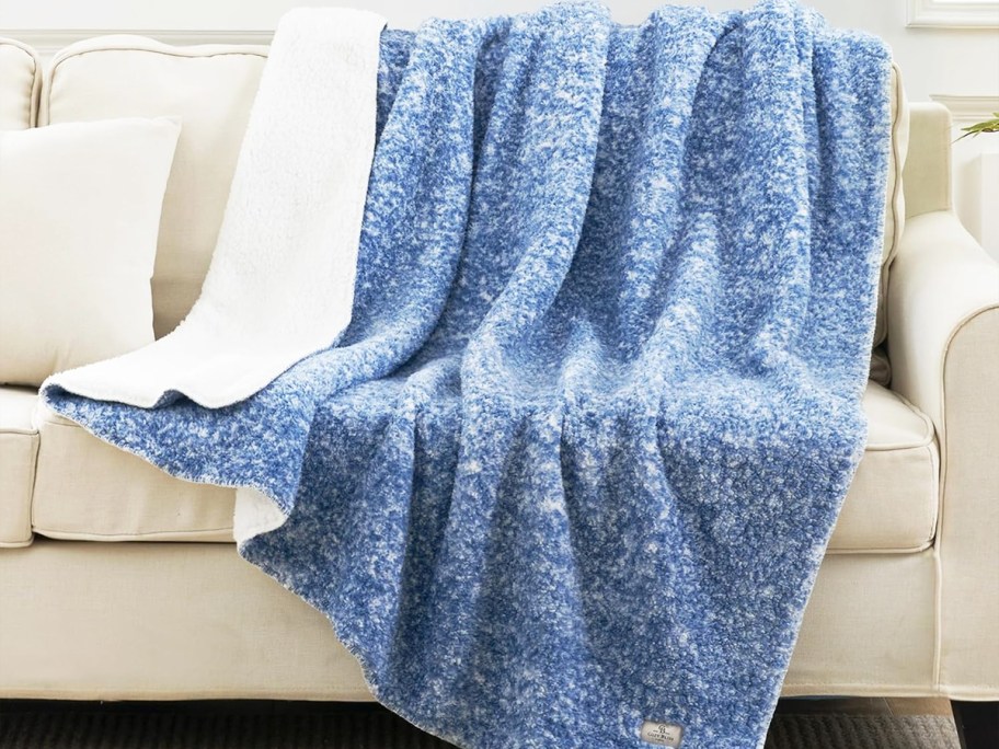 blue and white throw blanket draped over a couch