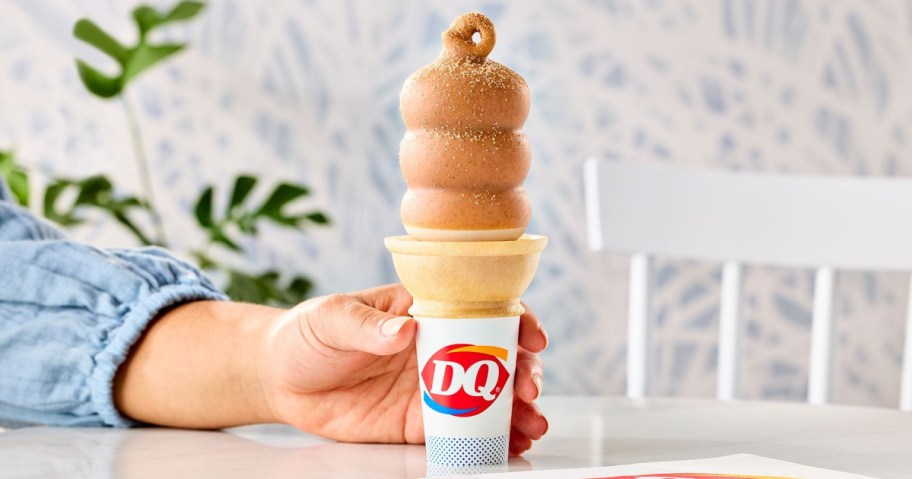DQ Cinnamon Toast Crunch Dipped Cone in hand on a table