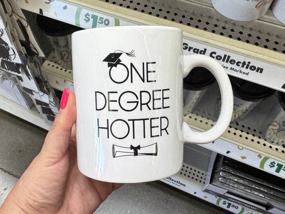 hand holding a graduation coffee mug in store