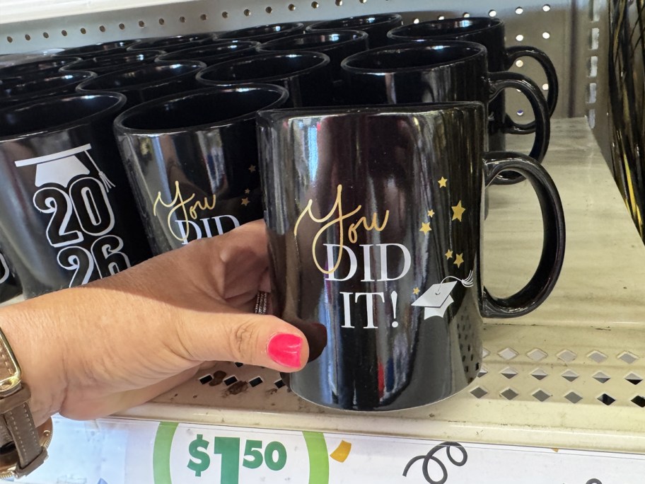 hand holding a graduation coffee mug in store
