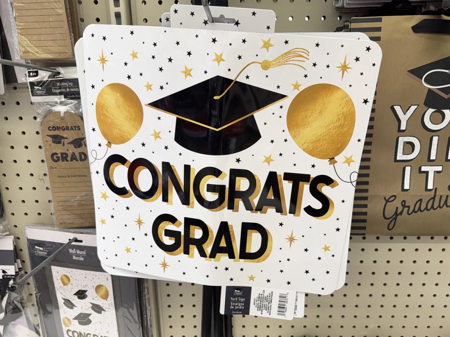 yard sign that says "congrats grad" on it