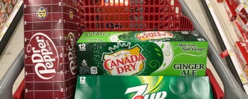 Dr Pepper, Canada Dry, and 7UP soda cases in a red shopping cart