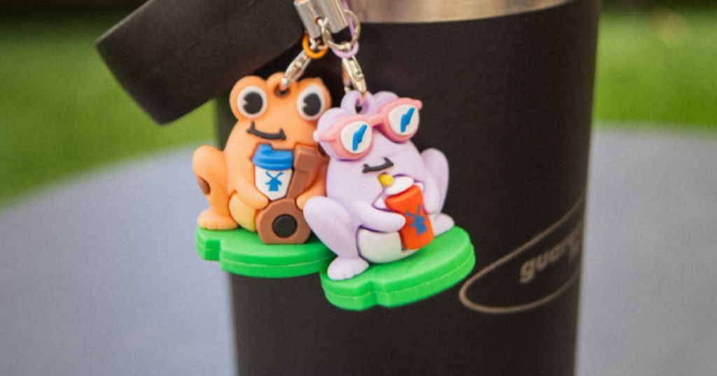 Frog charms hanging from black coffee Tumbler